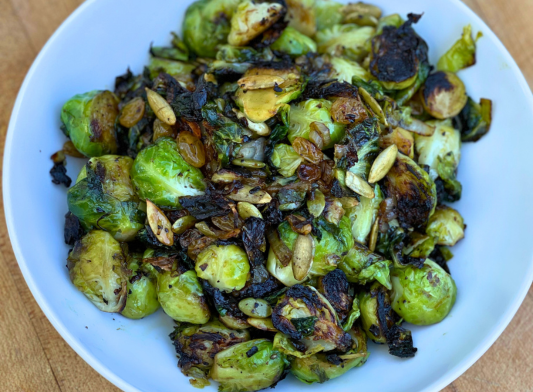 Cast Iron Brussel Sprouts with Maple, Golden Raisins, Pepitas